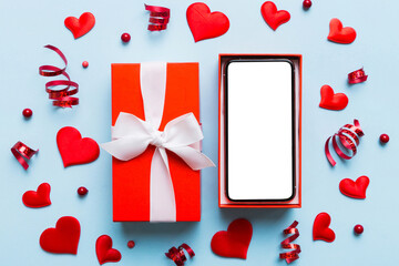 Wall Mural - Opened gift box with ribbon and phone on color background, top view. Blank open box packaging mockup , Template for your design - branding mockup