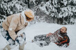 © qunica.com - A lively scene of friends enjoying a snowball fight surrounded by a snowy forest environment, showcasing joy and connection during winter outdoor activities.