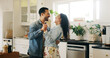 © peopleimages.com - People, couple and laugh with dancing in kitchen for anniversary celebration, bonding and fun. Man, woman and relationship with smile as newlyweds at home for care, support and trust with music