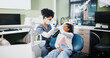 © peopleimages.com - Dentist, girl and high five with smile for results, motivation or support for oral health at hospital. Woman, child and celebration for teeth whitening, happy or tooth extraction with care at clinic