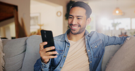Cellphone, relax and man on sofa in home for networking, social media or online communication. Happy, phone and male person chatting on dating app for contact or connection in living room at house.