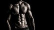 © Suphawan - Fit male torso in low light with dramatic shadows emphasizing six-pack and oblique muscles, black background