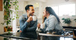 © peopleimages.com - Couple, laughing and drinking coffee with bonding in home for gossip, happy and funny conversation in kitchen. Man, woman and smile with beverage in house for support and relax with comic morning