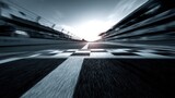 Motion blur view of race track finish line at speedway during daytime at eye level perspective