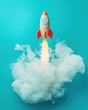 © EchoFrame - Rocket launch with smoke on blue background high angle view startup concept innovation and ambition with space rocket taking off