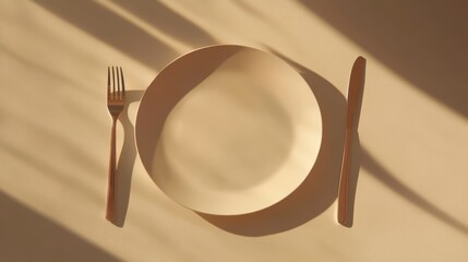 Poster - Empty plate with fork and knife, sunlit beige background.