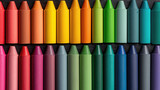Rows of colorful crayons arranged neatly on a dark, textured surface