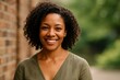 © Janja - Confident African-American Woman Smiling Outdoors in Natural Light