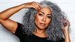© PB Studio - woman with curly gray hair struggling with frizz and volume, her hands attempting to tame the unruly strands. curly gray hair, frizz struggle, volume control, unmanageable texture, hands in