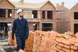 © Serhii - Portrait of a builder in the process of working on a construction site outdoors