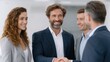 © Dzikrul Husnani - Business People Handshake in Office Setting with Smiling Colleagues
