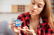 © Proxima Studio - Woman using a glucose monitor. Diabetic disease