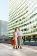 © Alberto - Senior couple walking and holding shopping bags in the city