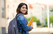 © Prostock-studio - Smiling Young Arab Female Student With Workbooks And Backpack Standing Outdoors, Happy Middle Eastern Millennial Woman Posing Outside At University Campus, Turning At Camera, Copy Space