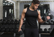 © Prostock-studio - Hispanic muscular man training with dumbbells in modern gym, copy space