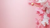 Pink and white orchid blossoms on pale pink background delicate floral design