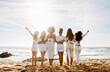 © Prostock-studio - Bride's team. Back view of group of young diverse women posing and embracing by the seashore, enjoying sunset and beautiful ocean view. Hen party celebration