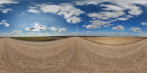 Wall Mural - hdri 360 panorama view on gravel road among fields with clouds in sky in equirectangular full seamle