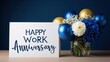 © H - Happy work anniversary card next to a vase with blue and gold balloons and white flowers