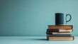 © Pixel - Stack of books with a mug on top, against a teal background
