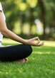 © Siasart Stock - Photo of Woman Meditating in Yoga Pose Outdoors on Green Grass