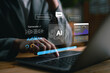 © Looker_Studio - Close-up of person using laptop with AI assistant interface. Concept of artificial intelligence, machine learning, chatbot technology, data analysis, and digital productivity tools.