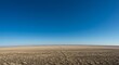 © Siasart Studio - Photo of a Brown Plowed Field Under Blue Sky
