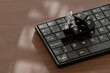 © Westend61 - Miniature 3D figures working on a keyboard in an office setting