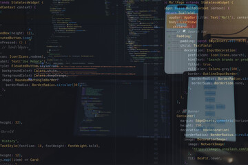 A focused app developer working on code at a computer, creating and testing features for a modern mobile application.