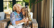 © peopleimages.com - Bonding, family or kiss with grandmother and grandchild on sofa in living room of retirement home for visit. Hug, love or relax with happy girl and old woman in apartment for weekend conversation