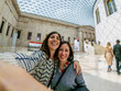 © unai - Tourists taking selfie at british museum great court in london