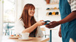 © peopleimages.com - Coffee shop, machine and woman with phone for waiter in cafe for customer service, pos and help. Restaurant, hospitality and person for online transaction, payment and purchase for breakfast waffles