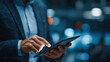 © Chandlerlikes - A security professional using a tablet to manage cybersecurity efforts and protect sensitive data in a professional setting