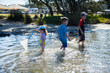 © Austockphoto - Three kids playing where the river meets the sea