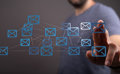 Fototapete - Image of a man interacting with a digital network of email icons, representing global communication and interconnectedness.