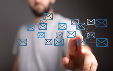 Fototapete - Person interacts with a digital network of email icons, representing global communication and interconnectedness.