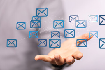 Fototapete - Hand holding network of email icons.  Digital communication, global connectivity, and networking concept.