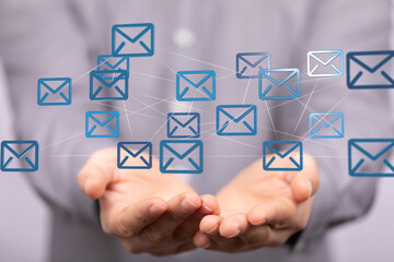 Fototapete - Image of hands holding a network of email icons, representing global communication and connectivity.