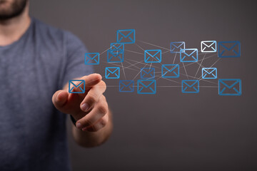 Fototapete - Hand interacting with a network of email icons.  Concept for communication, networking, and global reach.