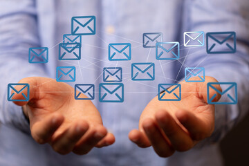 Poster - Businessman holding a network of email icons, symbolizing global communication and connectivity.
