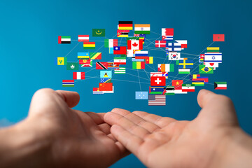 Leinwandbilder - Image of hands holding a network of world flags, symbolizing global connection and international relations.