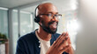 © peopleimages.com - Happy, black man and consultant with headset at call center for online communication or customer service. Male person, agent or smile with technology, mic or help for virtual assistance at office