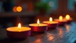 © yuwaree - Several votive candles burning, creating a warm glow , white, comfort, serenity
