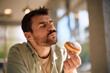 © Drazen - Man with eyes closed enjoying in taste of donut.