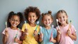 © Vadym - Group of children holding toothbrushes smiling. Happy kids care teeth, practice oral hygiene. Dental health, healthy smile, teeth brushing education. White background, kids smile.