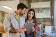 © Miljan Živković - happy couple stand in the kitchen and use digital tablet together