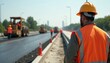 © Vadym - Worker in orange vest, helmet supervises road asphalt paving, highway construction. Road workers team laying asphalt on roadway. Infrastructure, transportation industry, teamwork, civil engineering.