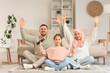 © Pixel-Shot - Muslim parents with their daughter watching TV at home