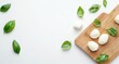 © black - Fresh mozzarella pearls & basil leaves on a wooden board