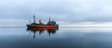 Orange And Blue Ship On Calm Frozen Water